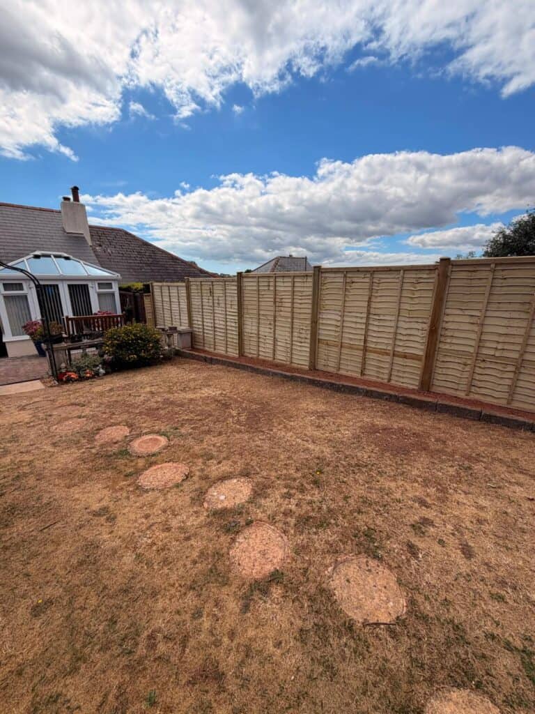 New wooden garden fence installed in Devon for privacy and security.